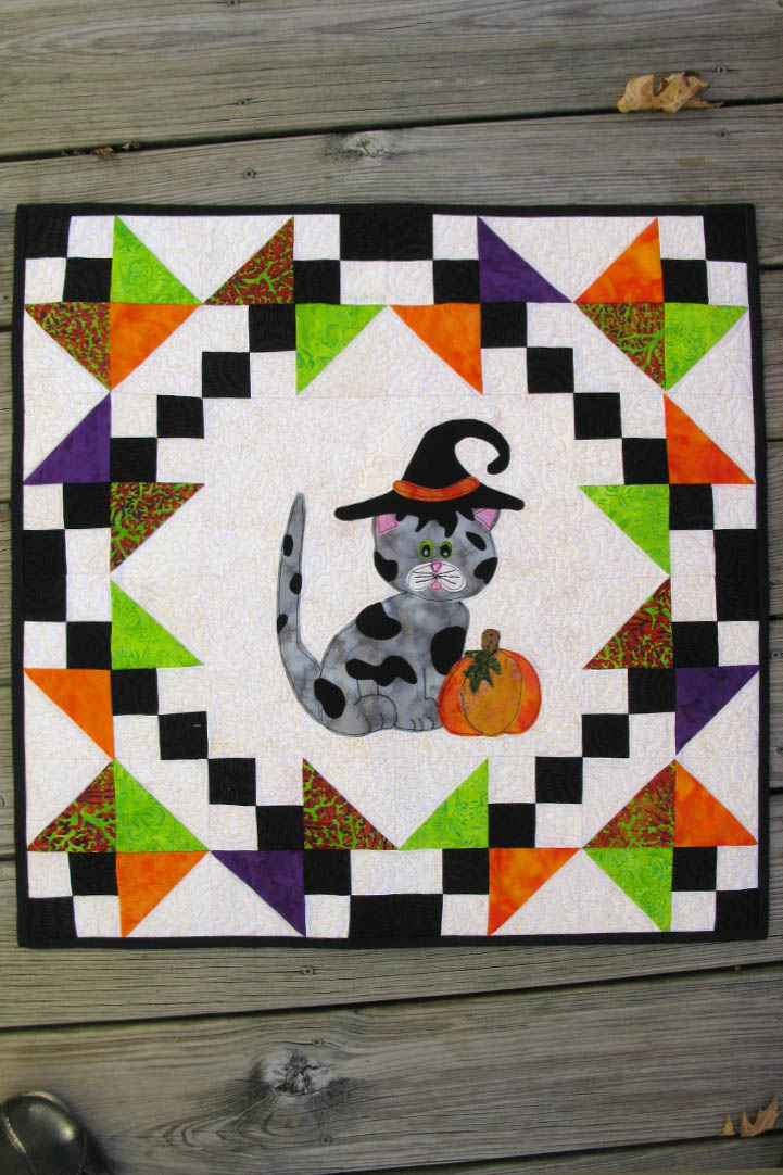 Kitty Kitty a cute applique quilt pattern, that has full size applique templates and full color diagrams to walk you through each step of the quilt.