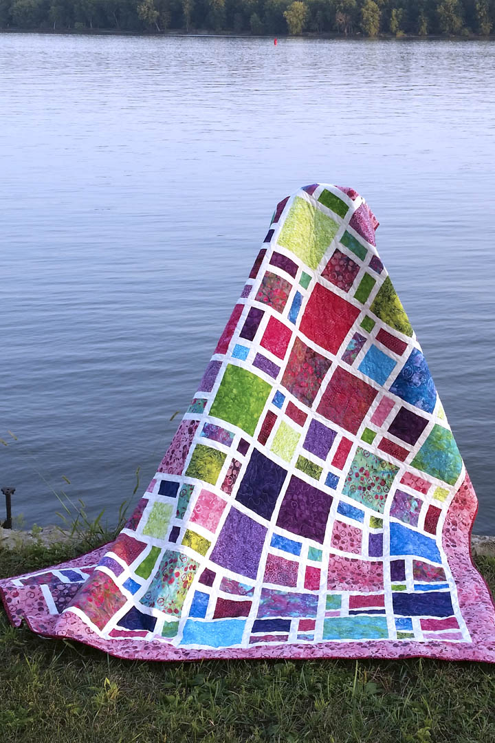 Scattered quilt pattern is fast and easy to make using bold and beautiful batiks or other fabrics for the blocks