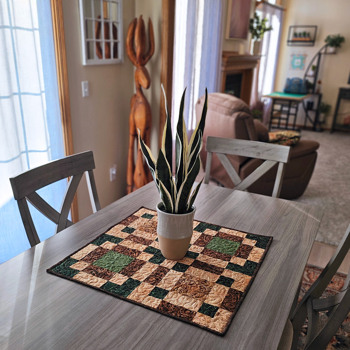 A table topper made from a type of disappearing 9 patch quilt block on dining room table
