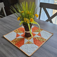 Orange Fall Four Patch Table Topper on table
