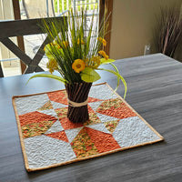 Orange Fall Four Patch Table Topper on table