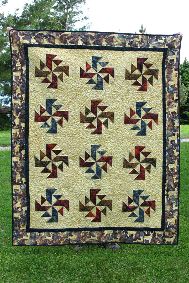 Crystals Swirls is a fast and easy quilt pattern that uses just one simple block set on point in a grass field