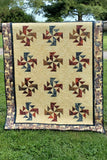 Crystals Swirls is a fast and easy quilt pattern that uses just one simple block set on point in a grass field