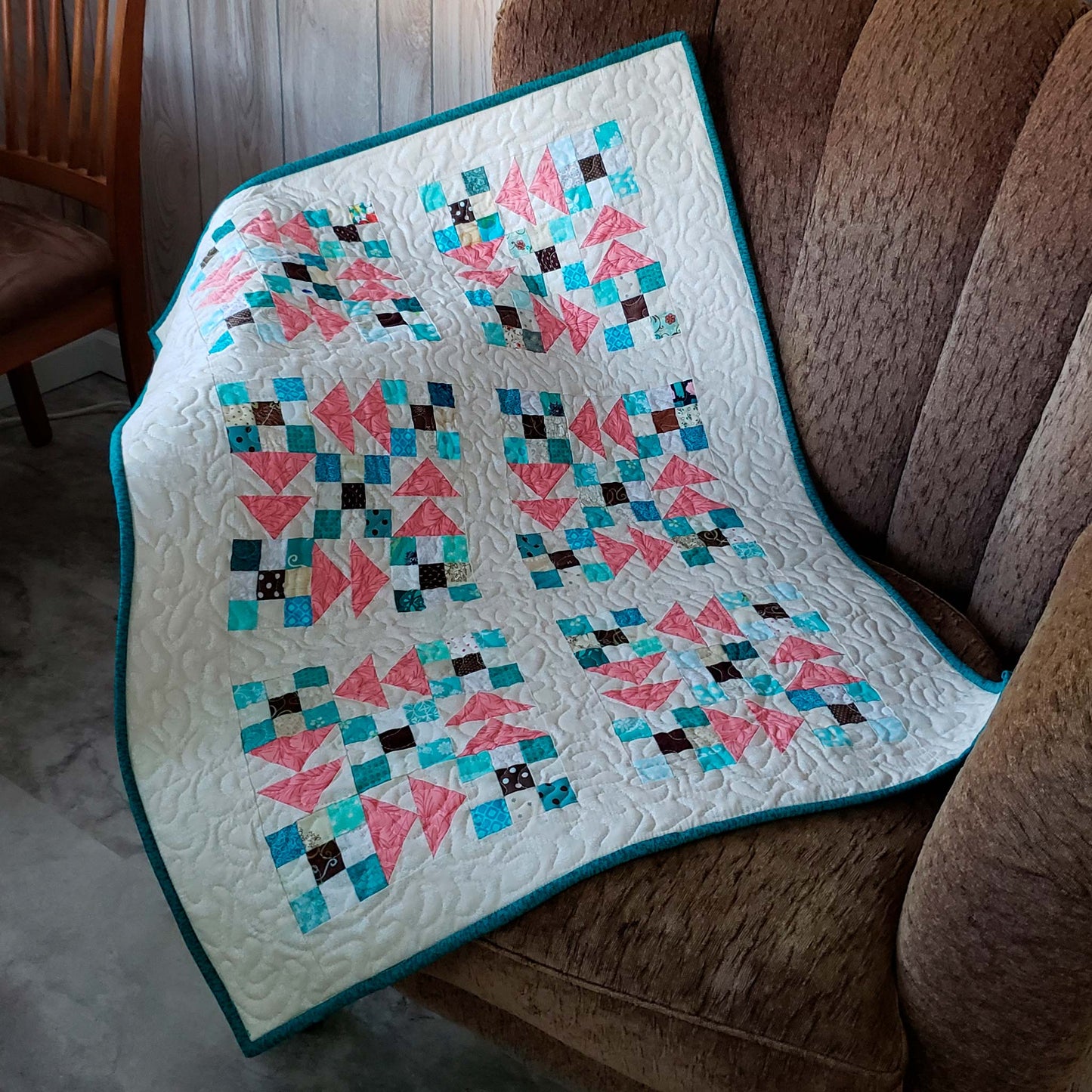 Flying Nines baby quilt on chair