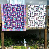 Hopscotch quilt pattern shown in two different colorways made with jelly rolls