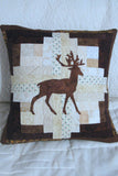 Applique deer on a log cabin block pillow that is 16 x 16