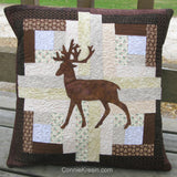 Appliqued deer on a log cabin quilt pillow