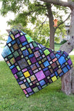 Scattered quilt pattern is fast and easy to make using black at the sashing for the blocks