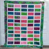Sparkles quilt in bright colorful fabrics flat view